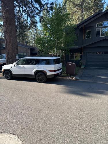 a white suv parked on the side of a street at Lake Tahoe Luxury Guest Quarters in South Lake Tahoe
