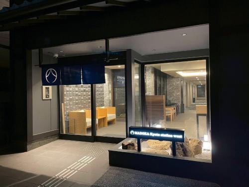 a store front with a sign in the window at MADOKA Kyoto station west in Kyoto