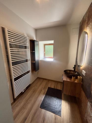 a bathroom with a sink and a mirror at Gästehaus zum Alpenjäger 