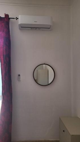 a mirror on a white wall with a mirror on the wall at Casa Manzoni in Novara