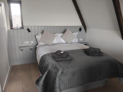 a bedroom with a bed with two towels on it at Wild Atlantic Pods in Portmagee