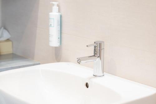 a bathroom sink with a soap dispenser on it at Hotel Florida Lerici in Lerici