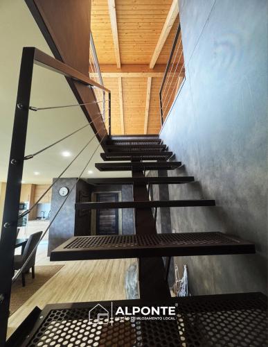 a spiral staircase in a building with wooden ceilings at Varanda do Cais BY ALPONTE in Caminha