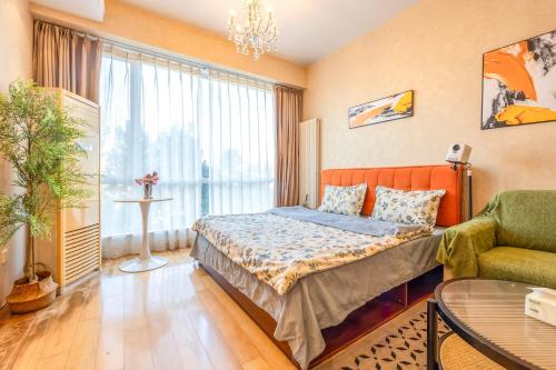 a hotel room with a bed and a couch at Beijing city center - Cosy family suite with city view in Beijing