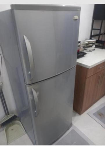 a stainless steel refrigerator in a kitchen at Climax Point Apt in Mandaue City