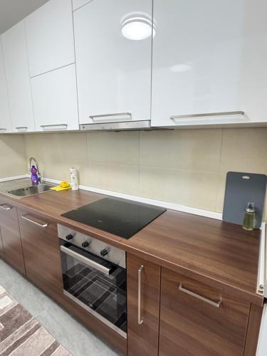 a kitchen with white cabinets and a stove top oven at Harmony residence Ilidza in Sarajevo