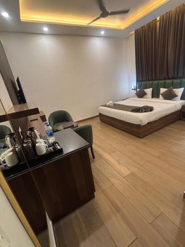 a hotel room with a bed and a desk at Hotel The Rivaaj in Rohtak
