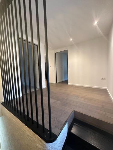 an empty room with a staircase in a building at UrbanNEST in Michelau