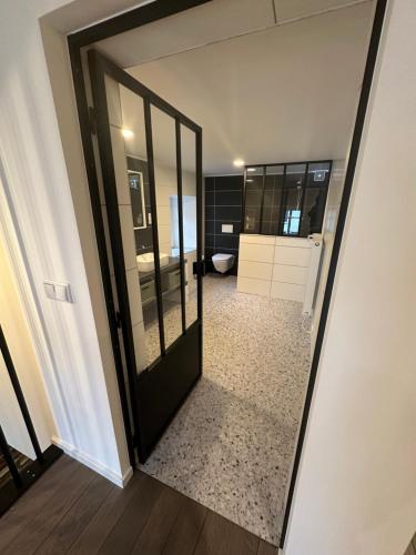 a mirror reflecting a bathroom with a toilet at UrbanNEST in Michelau
