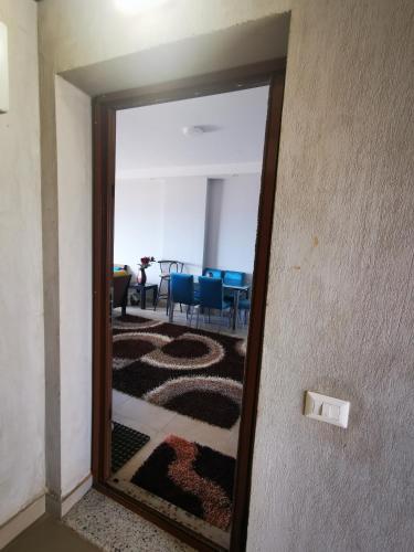 a mirror reflecting a room with a table and chairs at Sea Front Zen Chalet Families Only in Marsa Matruh