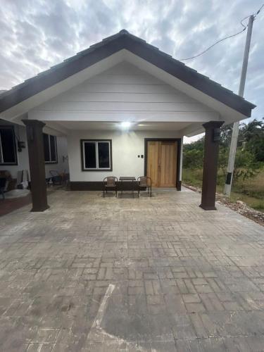 a small white house with a patio at Umaira Roomstay Arau in Arau