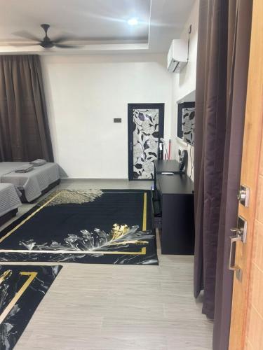 a room with a bedroom with a bed and a sink at Umaira Roomstay Arau in Arau