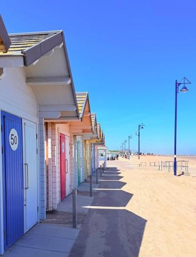 a row of beach houses on the beach at Lincolnshire Sunrise Views in Mablethorpe