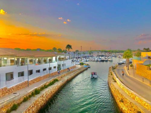 a view of a river with boats in a harbor at Fantástico apartamento "Sol y Sal" en Cala'n Bosch in Cala'n Bosch