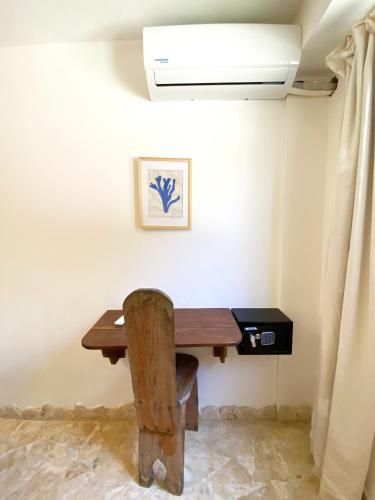 a table in the corner of a room with a ceiling at Surfbreak B&B in Cabarete