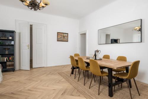 a dining room with a wooden table and yellow chairs at Apartment Nina in Bakar