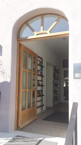 an archway with a wooden door in a building at Landhotel Adler in Sigmarszell