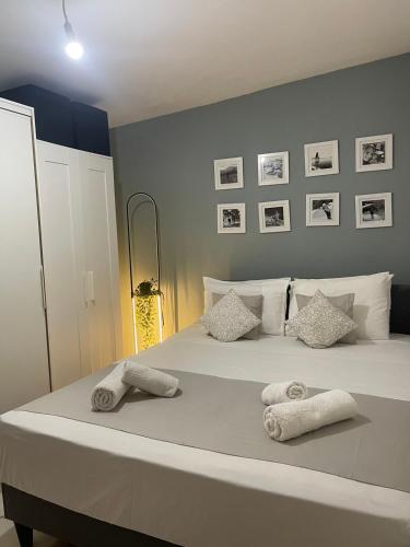 a bedroom with a large white bed with towels on it at Gogo's Cosy Beach House in Rethymno