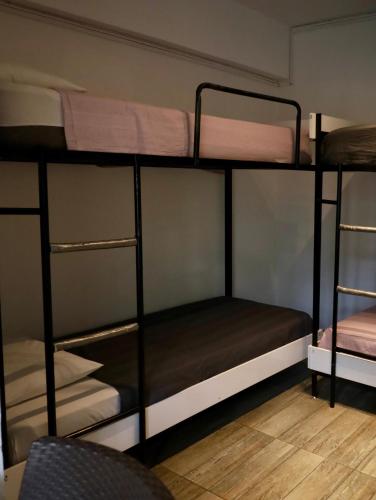 a room with three bunk beds in a room at Kuyu Beergarden Hostel in Antalya
