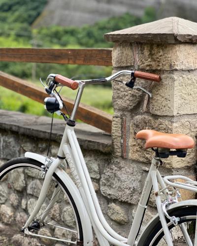 a white bike parked next to a stone wall at Mpoufidis Rock House Meteora in Kalabaka