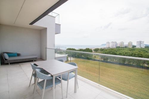 a balcony with a table and chairs and a large window at Hotel Residence Imperial in Misano Adriatico