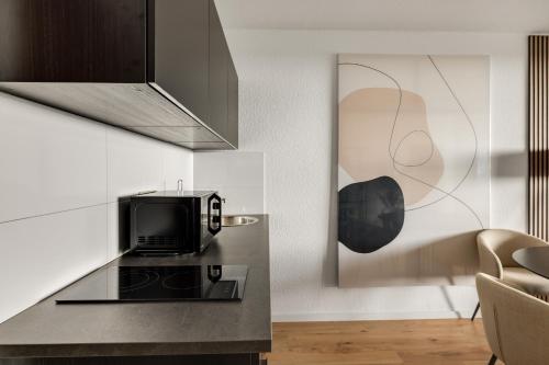 a kitchen with a counter top with a microwave at Beyond Living Horizon in Gelsenkirchen