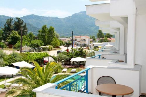 a balcony with a view of a town and mountains at Smaro Studios in Chrysi Ammoudia