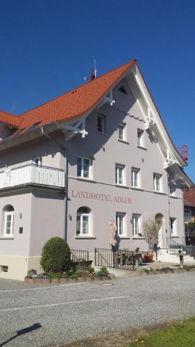 a large white building with a red roof at Landhotel Adler in Sigmarszell