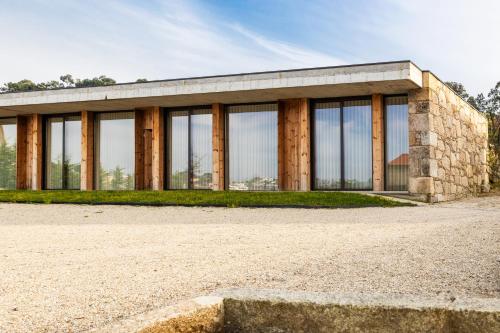 a building with glass windows on the side of it at Quinta da Torre - Anselmo Mendes 