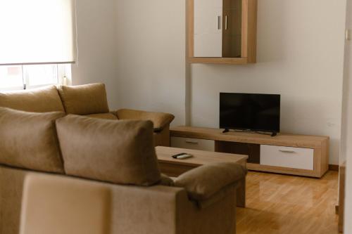 a living room with a couch and a tv at Albaceteloft Avenida España in Albacete