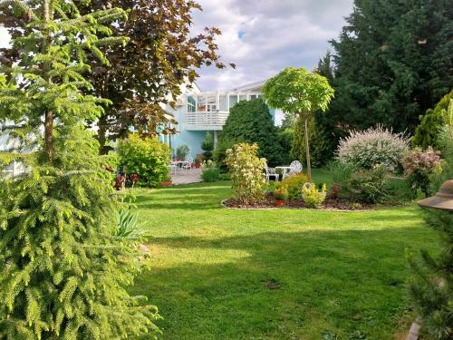 a garden with a house in the background at Cozy rooms in wine town - Modra in Modra