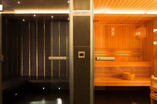 a shower in a room with wooden walls at H&ocirc;tel Moli&egrave;re in Paris