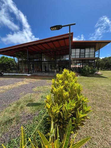 a building with a bush in front of it at Quinta DCristhi Lodge in Puerto Baquerizo Moreno