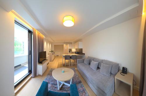 a living room with a couch and a table at Apartmani Zepterme by CENTRAL in Vrnjačka Banja