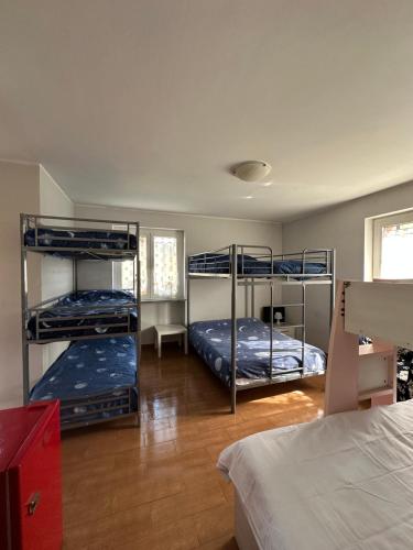 a room with three bunk beds in a room at La Quercia Fiorita in Trivolzio