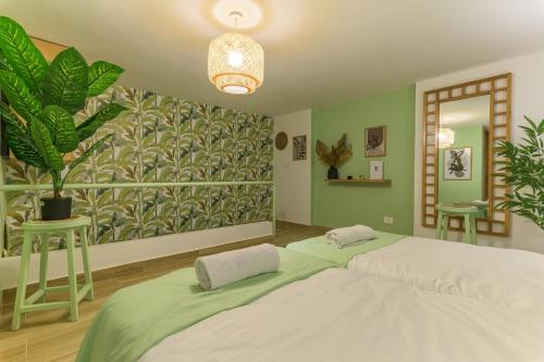 a bedroom with a large bed and a large mural at Jade Guesthouse In The Old Souks in Batroûn