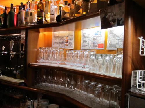 a bunch of glasses on a shelf in a bar at Hotel La Bussola in Padenghe sul Garda