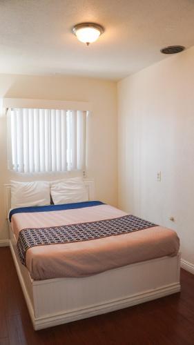 a bedroom with a bed with a large window at 777 Motor Inn in Sherman Oaks