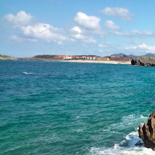 a large body of water with a beach in the background at Ático con Terraza en Isla in Isla