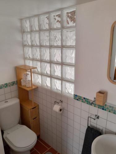 a bathroom with a white toilet and a sink at Casa Portao da Cidade in Silves