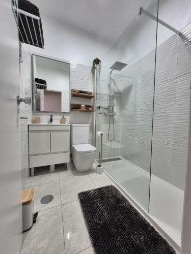 a bathroom with a shower and a toilet and a sink at Casa Portao da Cidade in Silves