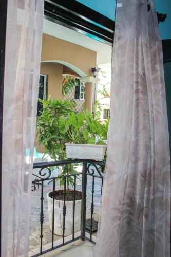 a balcony with a fence and a potted plant at hotel plaza BRISAS MT in Punta Cana