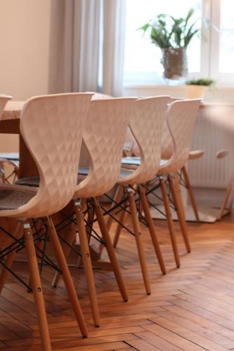 a wooden table with a bunch of chairs around it at Landhotel Adler in Sigmarszell