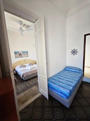 a bedroom with two beds and a mirror in it at La terrazza di Adele in Scoglitti