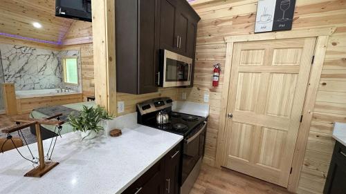 a kitchen with a stove and a door in a cabin at Brand New Luxury Cabin Full of Amenities 