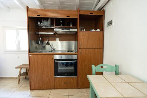 a kitchen with a sink and a stove at olivensun bungalow 3 in Gythio