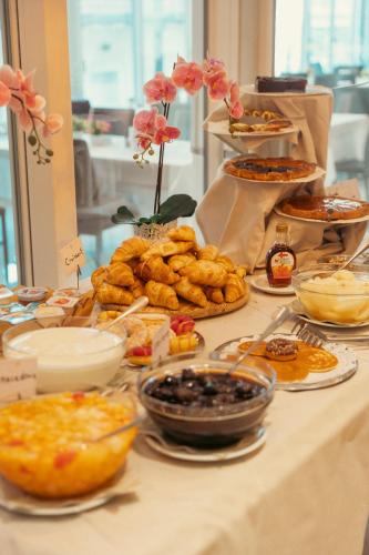 a table with a buffet of food on it at Hotel Rosa in Baveno