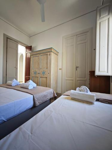 a bedroom with two beds with towels on them at La terrazza di Adele in Scoglitti