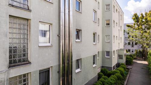 an apartment building with a street next to it at TreeTop Studio near MTP in Poznań