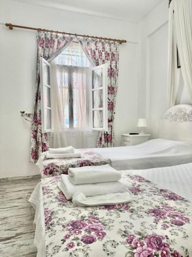 a bedroom with two beds with towels on them at Aişem By Hire in Alaçatı